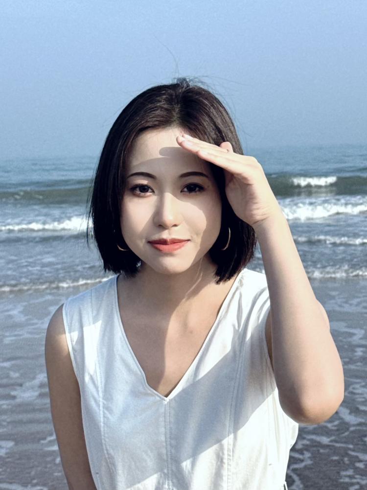 Wenxiu Wei standing by the sea